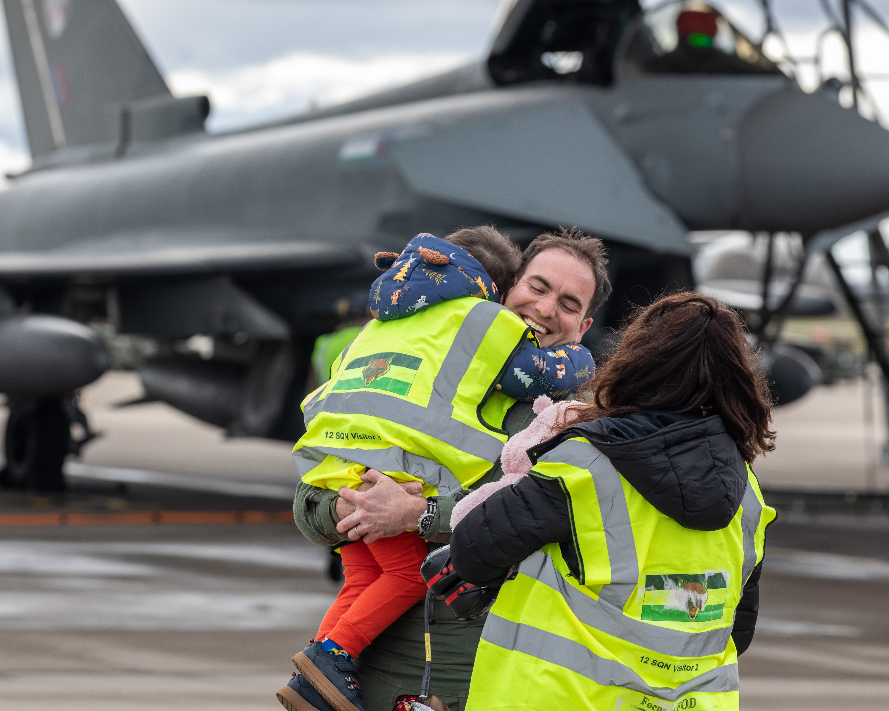 Image shows RAF aviator hugging son on the airfield by a Typhoon aircraft.